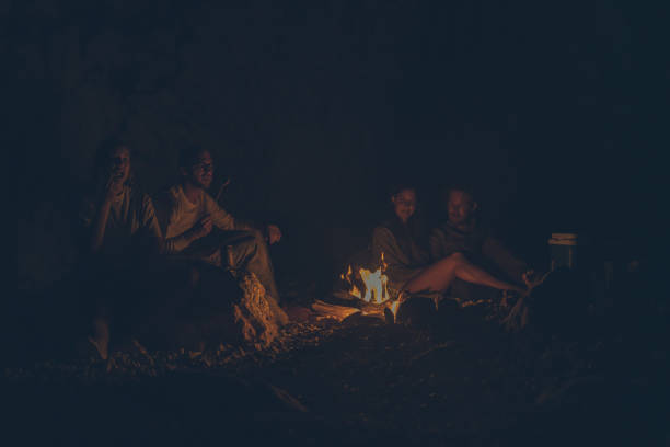 istock A group of friends relax by anbeach fire at night 1344728109