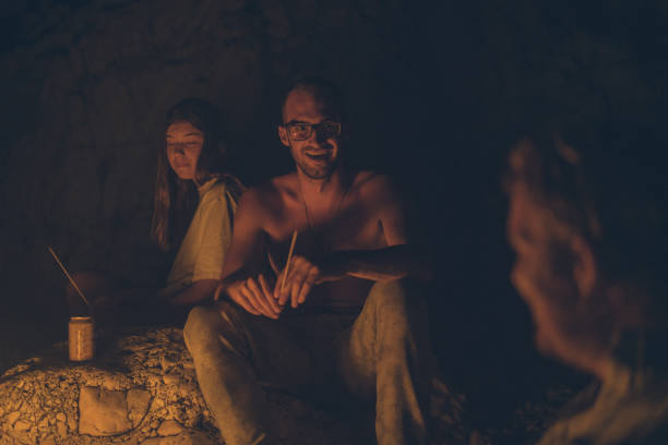 istock A group of friends relax by anbeach fire at night 1344728124