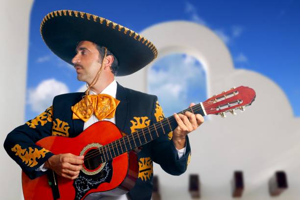 istock Charro Mariachi playing guitar Mexico houses 1344728493