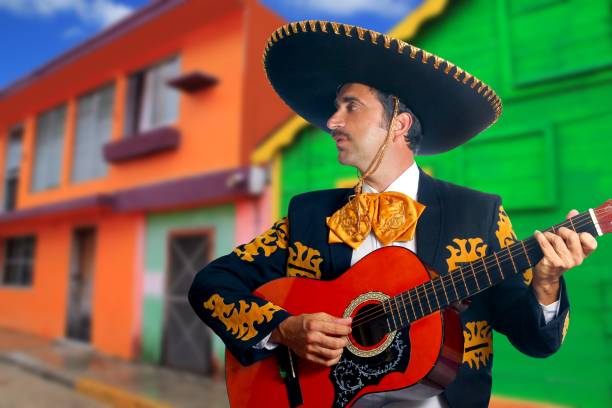 istock Charro Mariachi playing guitar Mexico houses 1344728517