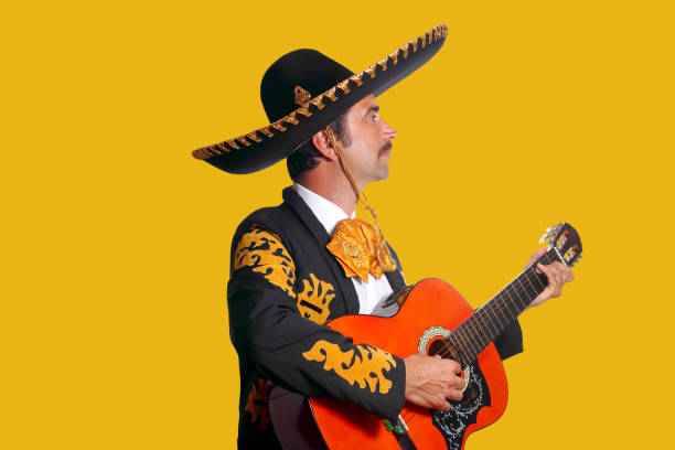 istock Charro Mariachi playing guitar on yellow 1344728550