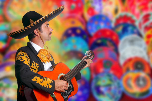 istock Charro Mariachi playing guitar over colorful blur 1344728564