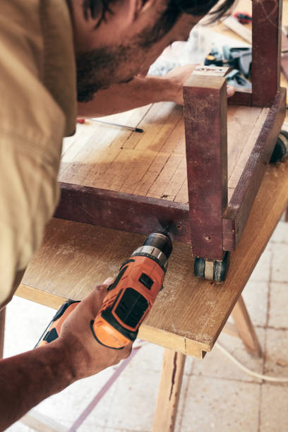 istock Man assembling furniture and fixing it - hobby concept. 1344728751