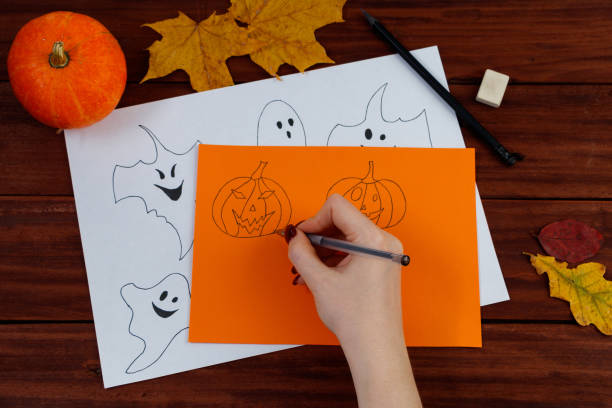 istock Halloween DIY. Cute pumpkins and paper ghosts. Step-by-step instruction. 1344730615