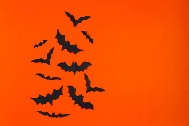 istock Happy Halloween. Paper bats on orange background. 1344730618
