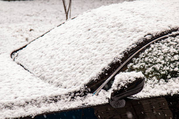 istock Car covered with snow in the winter blizzard.Extreme snowfall 1344731888