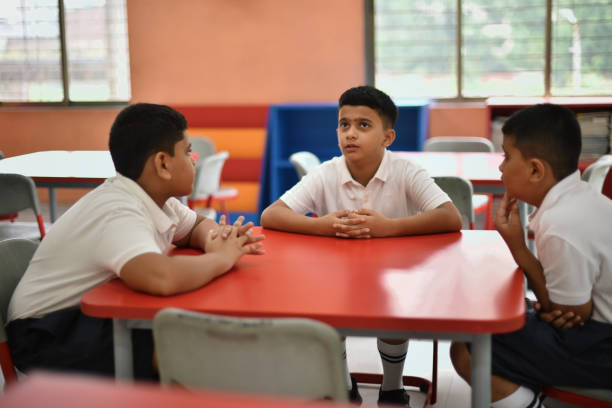istock School boys talking in the classroom 1344732497