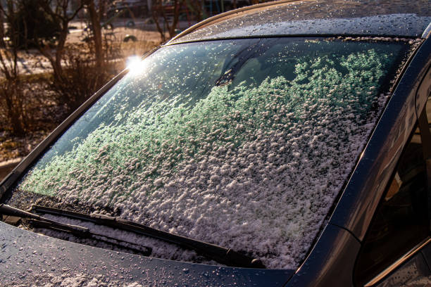 istock colored snow on a Sunny day, on a black car.late winter 1344733894