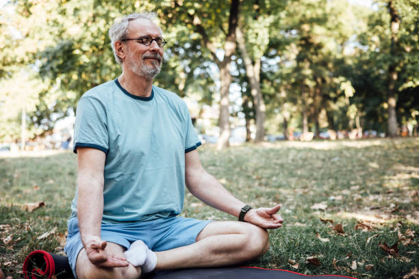 istock Mature man practicing meditation in the park 1344734662