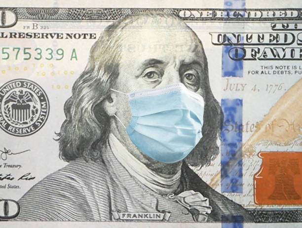 istock One hundred dollar banknote with face mask, closeup 1344734687