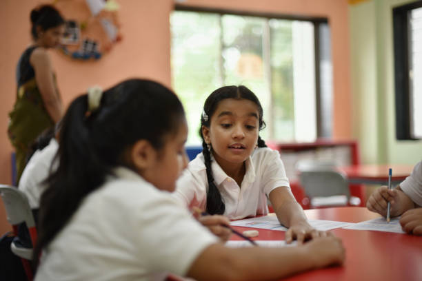 istock Girl student helping her classmate in 1344737628