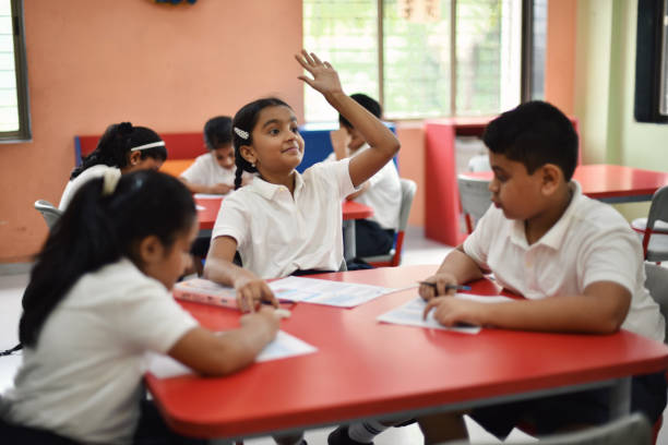 Students sitting in classroom and completing  the worksheets