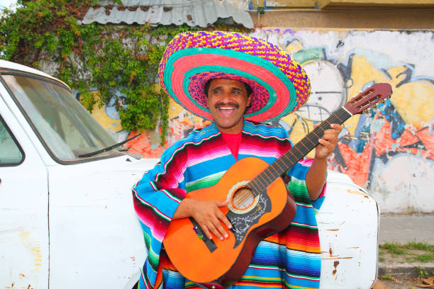 istock Mexican humor man smiling playing guitar sombrero 1344739146