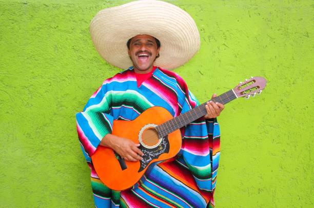 istock Mexican typical man playing guitar poncho 1344739935