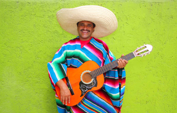 istock Mexican typical man playing guitar poncho 1344739988