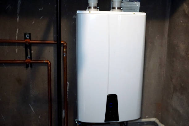 Tankless Hot Water Heater Tankless hot water heater installed in a basement utility room to save money and energy. boiler stock pictures, royalty-free photos & images