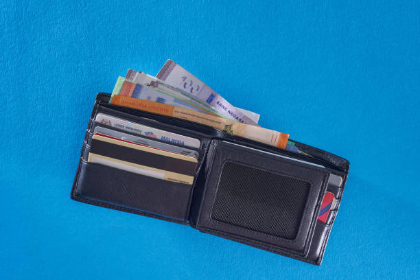 istock top view of brown color wallet on blue background 1344742236