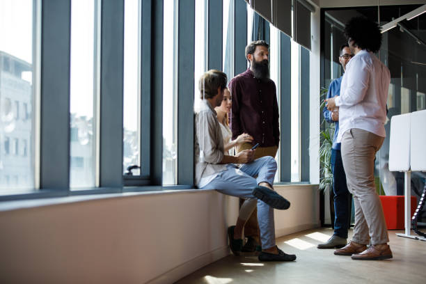 istock Five business colleagues spending coffee break chatting and hanging out together 1344743236