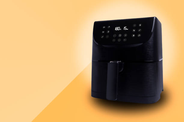 istock Air Fryer isolated on light orange background with copy space. 1344743346