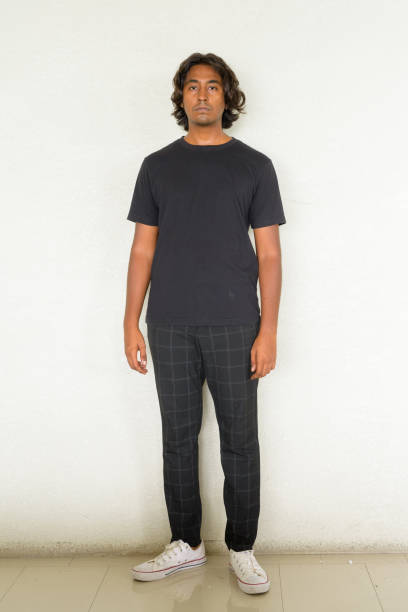 istock Full length portrait of handsome young Indian man standing against plain background 1344743607