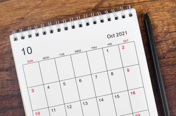 istock October 2021 desk calendar with wooden pencil. 1344743710