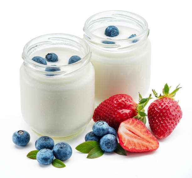 istock Two glass containers with plain yoghurt and berries isolated on white background. 1344743930