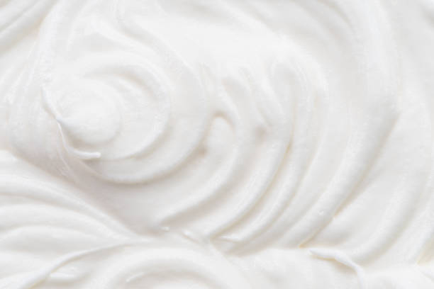istock Creamy waves and swirls in yoghurt or cream surface. Top view. 1344743975