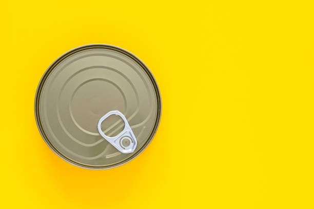 istock Round tin can on yellow background. Copy space 1344744890