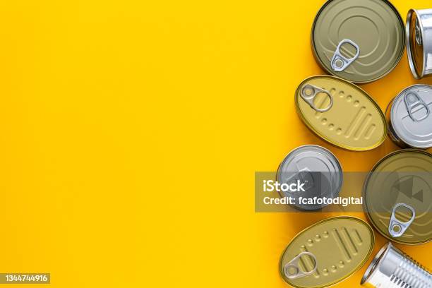 Tin Cans Border On Yellow Background Stock Photo - Download Image Now - At The Edge Of, Blank, Can