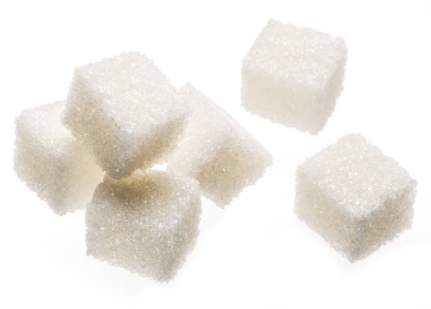 istock White sugar cubes on white background. Macro picture. 1344745498