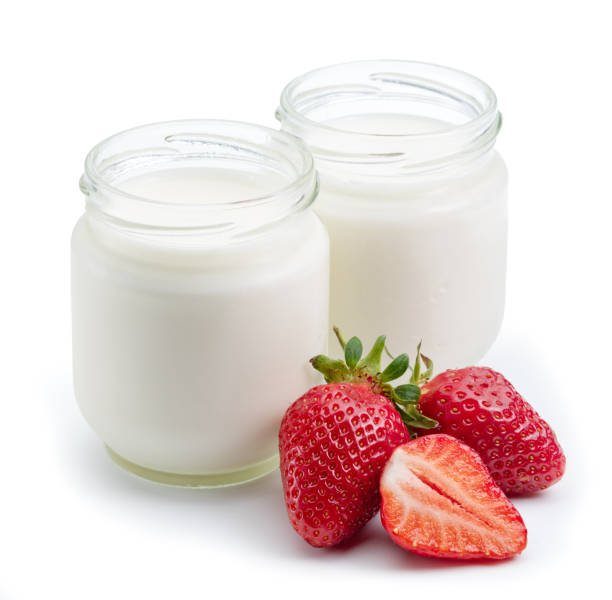 istock Two glass containers with plain yoghurt and berries isolated on white background. 1344746327