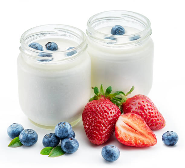 istock Two glass containers with plain yoghurt and berries isolated on white background. 1344746381