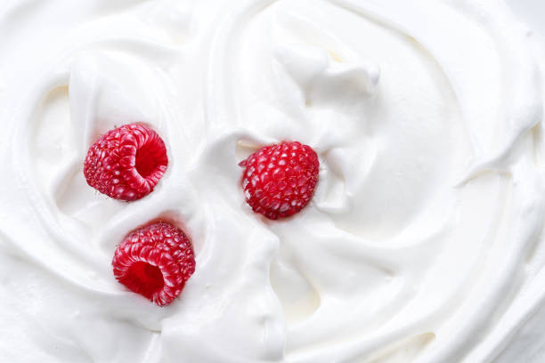 istock Fresh raspberries in the yoghurt or cream. Top view. 1344746408