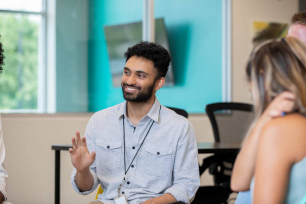 istock Man waving his hand at a meeting 1344746653