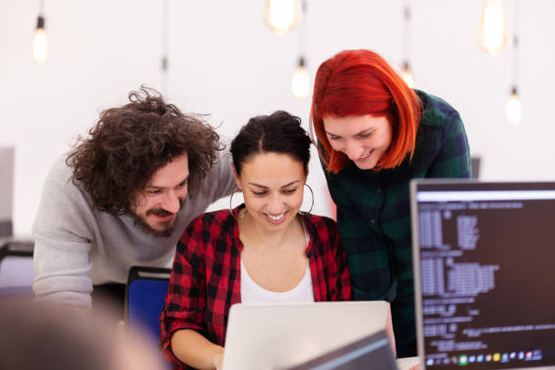 istock Casual colleagues working on computers in a modern coworking office space. 1344748010