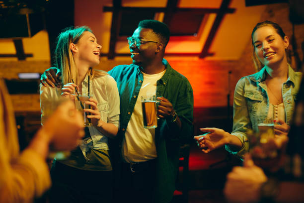 istock Young happy adults having fun on night party in a pub. 1344748892