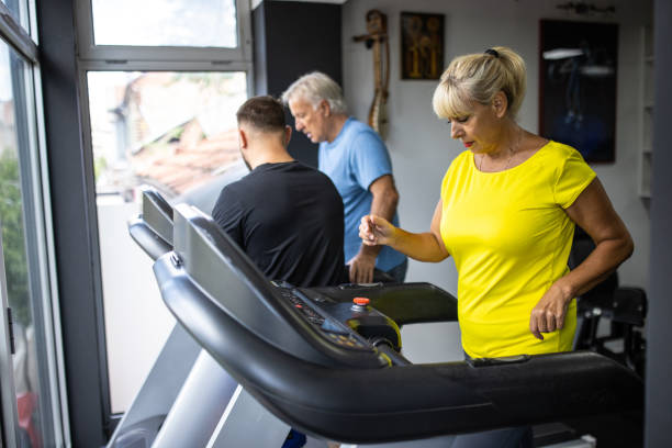 istock Senior woman using treadmill in gym 1344749757