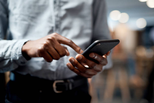istock Shot of an unrecognisable businessman using a smartphone in a modern office 1344749974