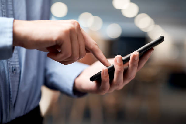 istock Shot of an unrecognisable businessman using a smartphone in a modern office 1344749999