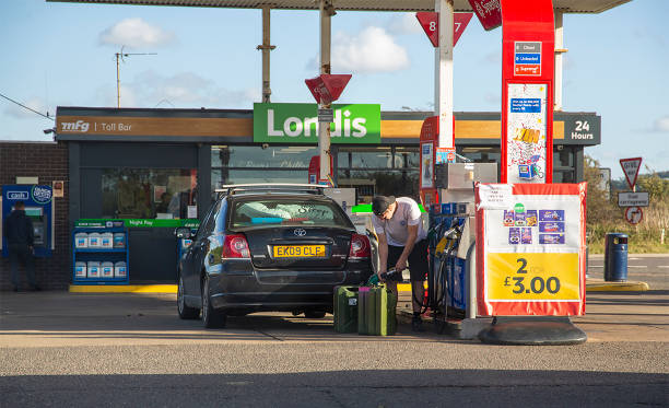 A Man Fills up Jerry Cans at Petrol Station, at Toll Bar Fuel Station in England. Photo Taken by Amber Rowan Roberts on October 1st 2021 A Man Fills up Jerry Cans at Petrol Station, at Toll Bar Fuel Station in England. Photo Taken by Amber Rowan Roberts on October 1st 2021 doncaster photos stock pictures, royalty-free photos & images