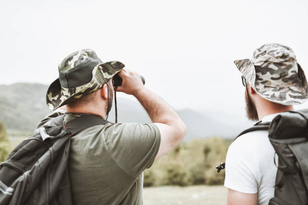 istock Two Male Hikers Using Binoculars To Look At Beautiful Pastures Of Mountain 1344751173