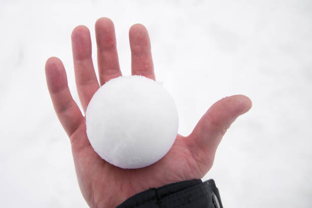 istock snowball in bare hand. snowball melts in bare hand 1344752202