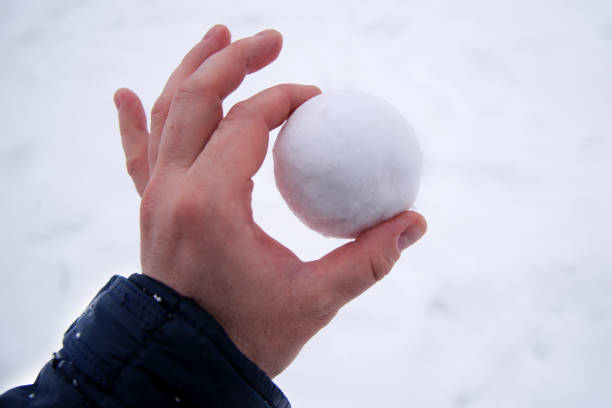 istock snowball in bare hand. snowball melts in bare hand 1344752295