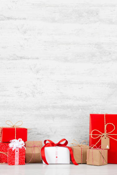istock Heap of Christmas Gift Boxes on Wooden Table 1344752934