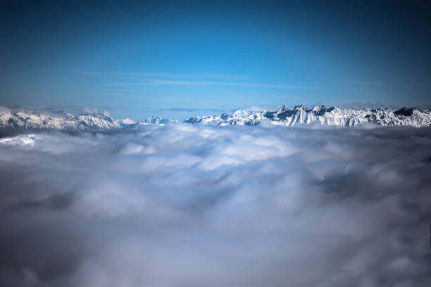istock Snow covered mountains in the sky 1344753603