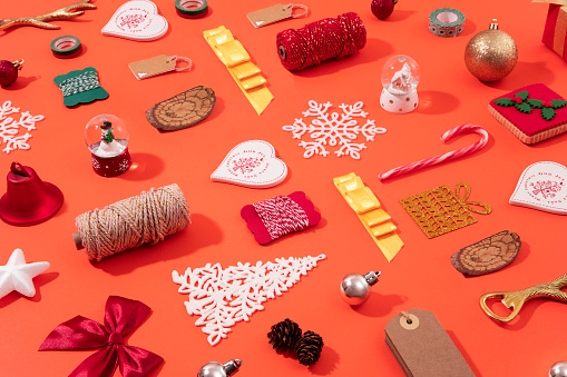 Christmas background decoration with ornaments and objects on orange colored background