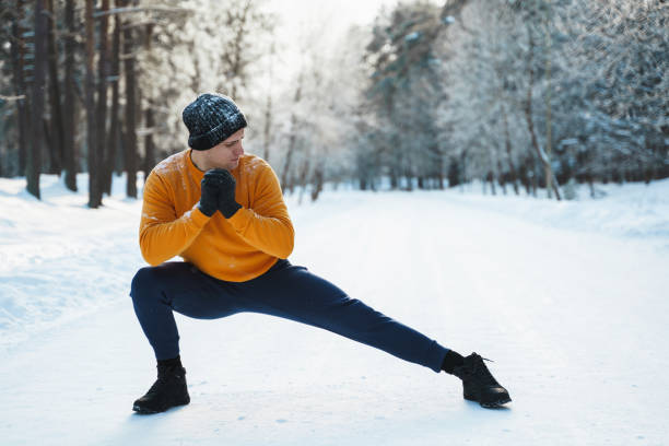 istock Athletic man doing warming up before his winter workout in snowy 1344754468