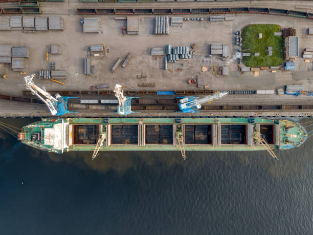 istock Aerial view from above on dockside with boat and cranes. 1344755133