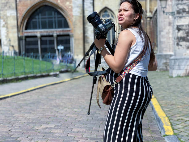 istock Pregnant Photographer in action 1344755330