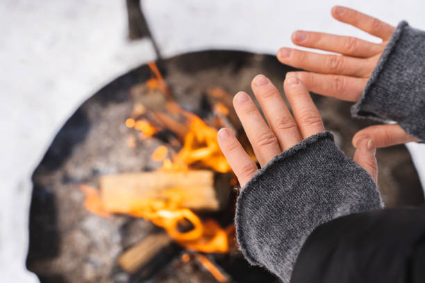 istock Woman warming up her hands by the fire pit 1344756015